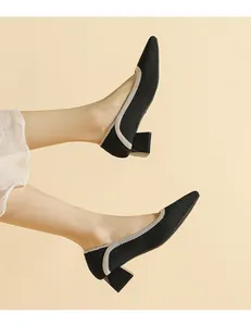 Close-up detail of black knitted pointed-toe women pumps with comfortable block heels