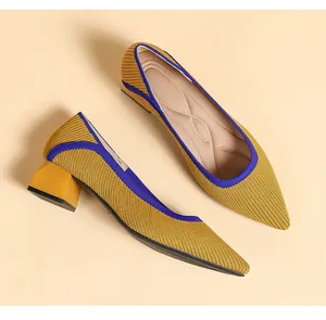 Macro view of the yellow knitted texture and block heel on these pointed-toe pumps