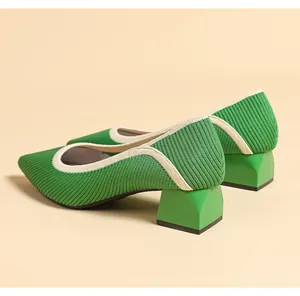 Detail showing green knit texture and block heel of stylish pointed-toe pumps