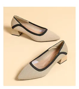 Detailed view of women's beige knitted pointed-toe pumps with black trim and block heels