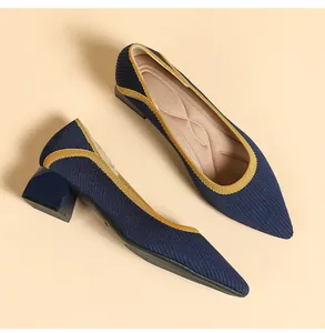 Detailed view of breathable navy blue knitted pointed-toe pumps with chunky heels