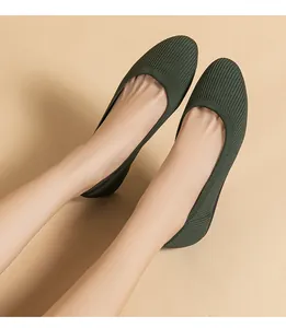Gros plan détaillé de ballerines en tricot vert foncé à bout rond sur les pieds
