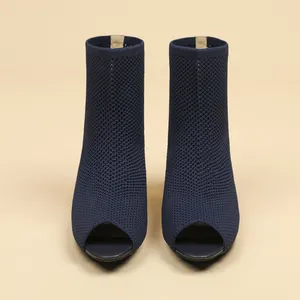 Front view of navy blue knitted peep-toe ankle boots showing fine mesh texture.