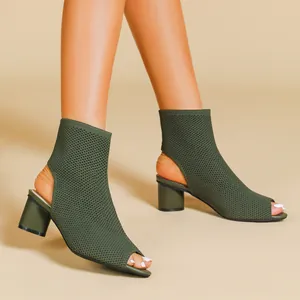 Detail view of olive green knitted peep-toe chunky heel ankle boots with cutout heel