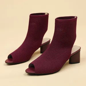 Detailed close-up of burgundy peep-toe knit slingback boots featuring chunky block heel