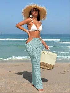 Detailed view of light blue hollow-out crochet maxi skirt styled for beach vacation