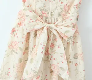 Macro view of floral print summer dress detailing the elegant large bow waist tie
