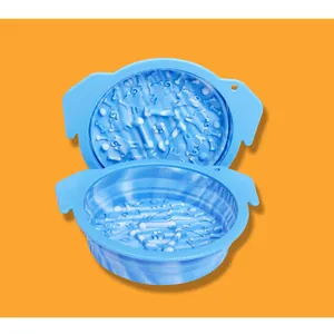 Close-up detail of blue silicone slow feeder pet bowl with 3D bone and dog patterns