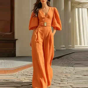 Detail view of stylish orange deep V-neck jumpsuit with puff sleeves and matching belt