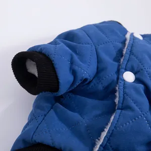 Detailed view of a blue quilted warm pet vest with white fleece lining for dogs and cats