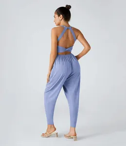 Back view detail of a sexy blue halter neck jumpsuit with cutout strappy back