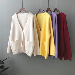 Close-up of loose V-neck knitted cardigans with pockets in multiple colors.
