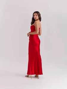 Detailed side view of an elegant red strapless satin evening gown on a fashion model