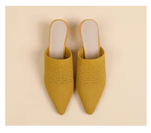 Top view of elegant yellow pointed-toe knit mules with breathable hollow texture