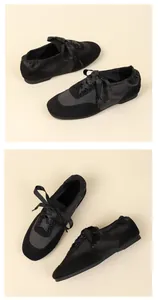Detail view of black satin ballet flats with ribbon laces and suede accents