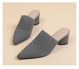 Close-up view of grey pointed-toe knit mule sandals with elegant chunky mid-heels