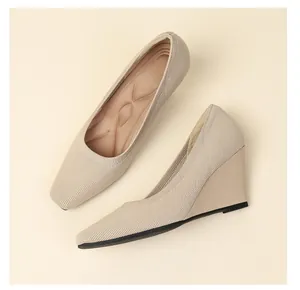 Detail view showing breathable knit texture and comfortable cushioned insole of wedge heels