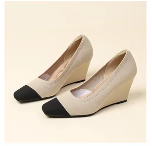 Close-up view of elegant square-toe wedge pumps featuring beige knit and black toe cap
