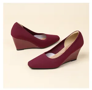Close-up of burgundy knitted wedge pumps featuring a breathable woven texture.