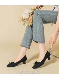 Elegant black knit square-toe chunky heel pumps featuring a stylish front bow detail