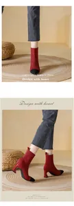 Detailed side view of red knitted ankle boots with black pointed toes and high heels