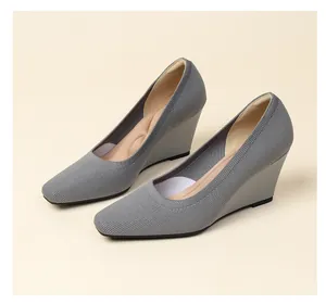 Detailed close-up of grey knitted wedge high heels featuring breathable square toe design