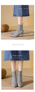 Detailed macro view showing the grey knitted fabric of pointed-toe high-heel ankle boots