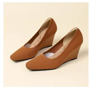 Detail view showing the breathable knitted texture of tan square-toe wedge heels.