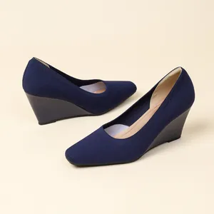 Elegant navy blue knit wedge heels featuring a square toe design and breathable stretch fabric