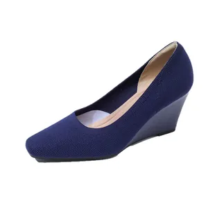 Navy blue square toe wedge pumps featuring a breathable knitted elastic woven upper
