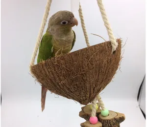 Detailed view of a natural coconut shell bird nest swing with parrot in bird cage