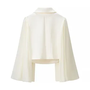 Detailed back view of an elegant white cropped blazer with dramatic flared sleeves