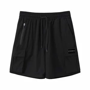 Close-up of men's quick-dry black cargo shorts featuring multi-pocket design and drawstrings.