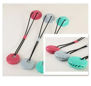 Close-up of durable pet molar toys with suction cups and textured surfaces in multiple colors.