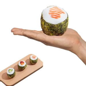 Close-up macro view of realistic sushi-shaped plush cat toys with catnip on a wooden board