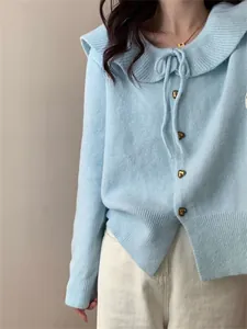 Detailed view of light blue Korean style knit cardigan with Peter Pan collar and heart buttons