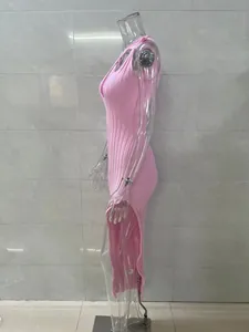 Side view of pink ribbed knit maxi dress with high side slit on clear mannequin