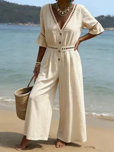 Casual beige V-neck jumpsuit with lace detail and short sleeves for beach holiday