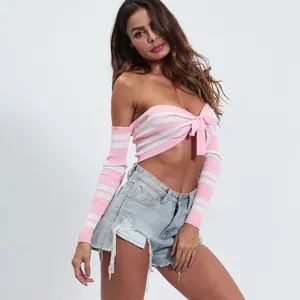 Detail view of pink and white striped knit crop top with front bow accent and long sleeves