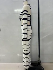 Side profile of striped crochet two-piece set with halter top and maxi skirt