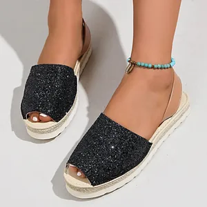 Detail view of sparkly black glitter flat sandals with a comfortable open-toe design