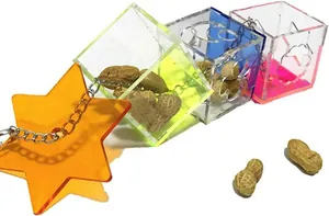 Macro view of colorful acrylic bird foraging toy cubes with star and metal chain