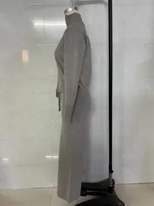 Side profile detail of elegant grey knit zip-up cardigan and straight pants two-piece set