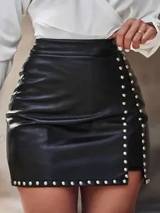 Elegant black faux leather mini skirt with silver stud detailing and side slit