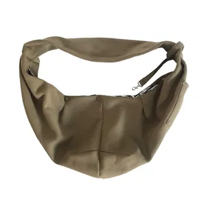 Close-up of durable brown pet sling carrier with safety leash and snap buttons