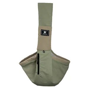 Front view of a sage green portable pet sling carrier with wide shoulder strap