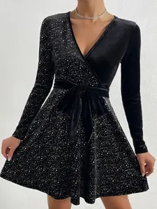 Elegant black V-neck party dress featuring sequin details and long sleeves with tie waist