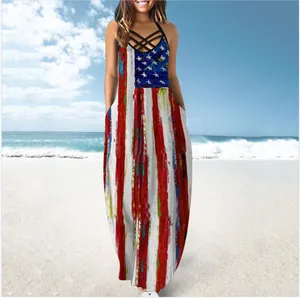 Casual women's summer maxi dress featuring an American flag print and halter neck on a beach
