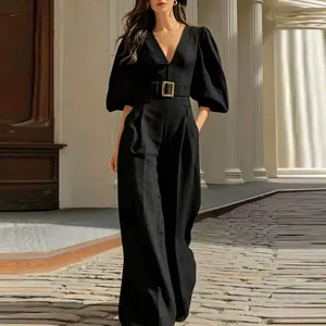 Detail of an elegant black deep V-neck jumpsuit with belt and wide-leg trousers