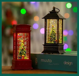 Detailed view of lit Christmas telephone booth and lantern snow globes with glitter